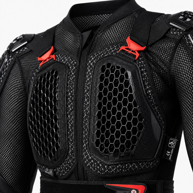Close-up of a black protective racing jacket with honeycomb mesh panels and bright red adjustment straps on a light gray background.