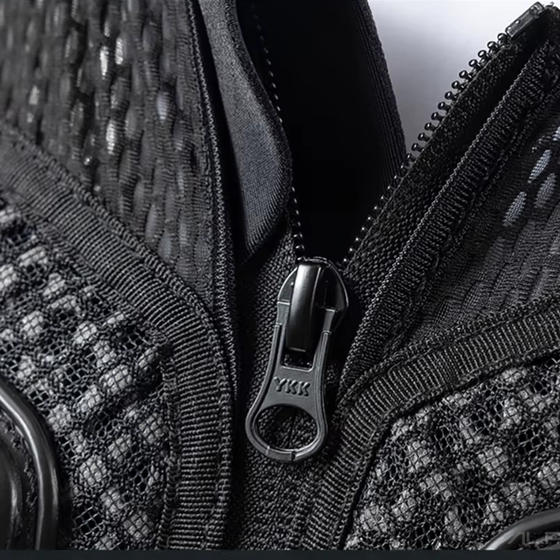 Close-up of a black textured mesh and woven bag with a black metal zipper and a visible YKK logo on the zipper pull.