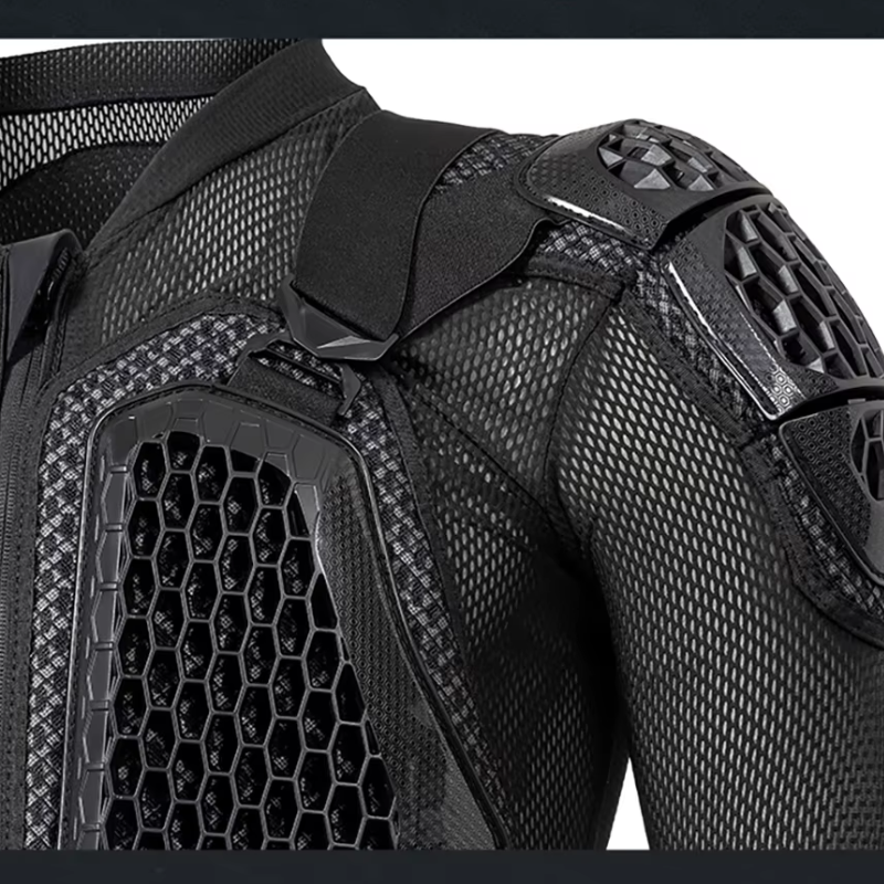 Close-up of a black protective sports jacket showing the shoulder, upper chest, and back panels with breathable mesh and hard shell protection.