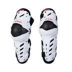 Pair of white and black protective knee pads with visible branding on a white background