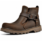 A dark brown leather ankle boot with a buckle strap across the instep and a rugged lug sole, shown from a side profile on a white background.