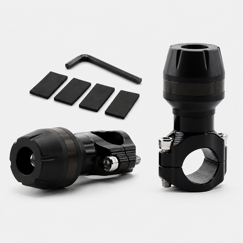 Black metal bike clamp accessory set with a clamp assembly shown upright and angled, a matching clamp piece lying down, four black rubber pads, and a small hex key on a light gray background.