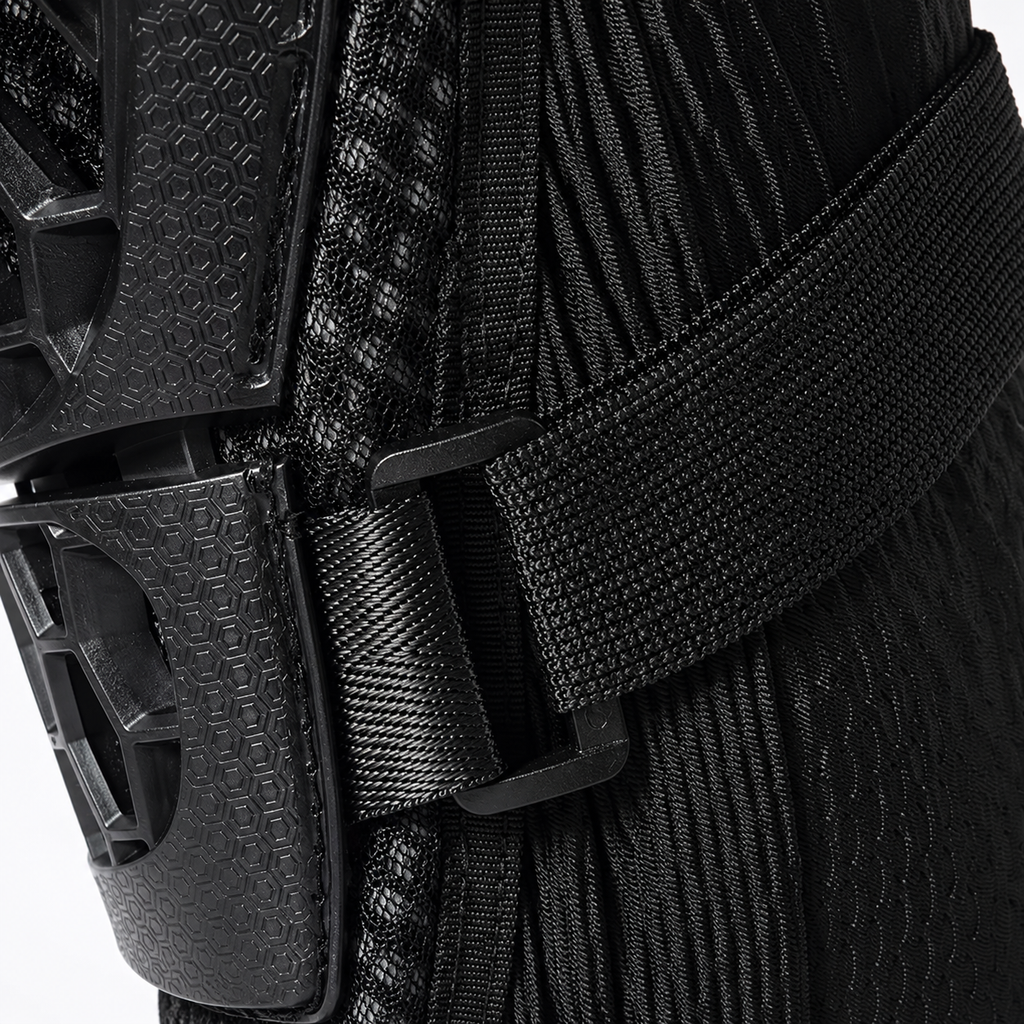 Close-up of a black protective gear item with a textured ribbed fabric body, a wide black strap, and a black plastic buckle.