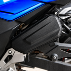 A black carbon-fiber-pattern motorcycle side bag mounted on the side of a blue and black motorcycle.
