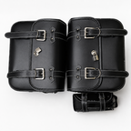 A pair of black leather motorcycle saddlebags with silver buckles, a zip closure, and a small lock, displayed on a clean white background.