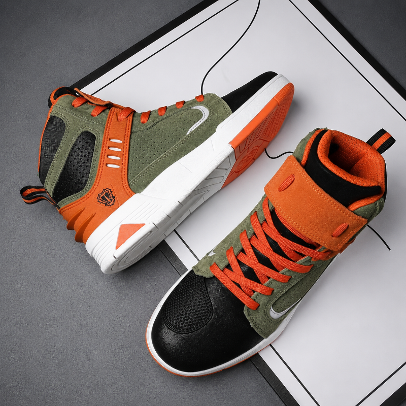 A pair of high-top athletic sneakers shown from angled top and side views on a white graphic sheet over a dark gray surface. The shoes feature an olive green suede upper, bright orange overlays and laces, black mesh toe and heel panels, a white midsole, and a small black tiger emblem on the side.