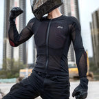 A person wearing a black full-face motorcycle helmet, black long-sleeve riding jersey, black pants, and black gloves poses outdoors with city buildings blurred in the background. White text at the top reads 'PRODUCT DISPLAY'.
