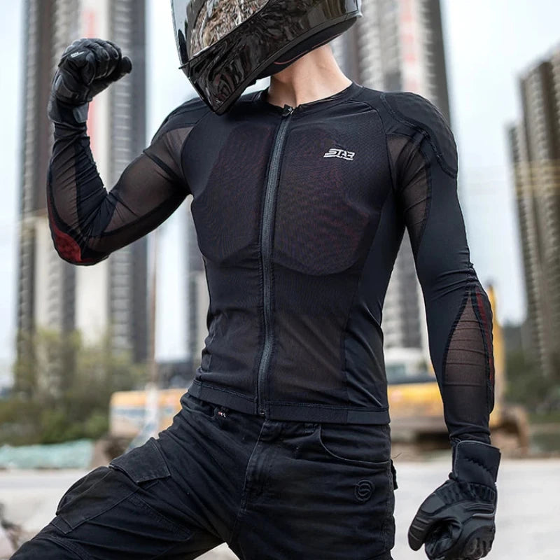 A person wearing a black full-face motorcycle helmet, black long-sleeve riding jersey, black pants, and black gloves poses outdoors with city buildings blurred in the background. White text at the top reads 'PRODUCT DISPLAY'.
