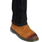 A close-up of a brown suede lace-up boot worn with dark blue jeans, shown against a plain white background.