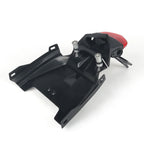 Black plastic motorcycle rear fender and body panel with silver mounting bolts and a small red taillight, shown on a white background.