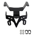 A black metal motorcycle license plate frame with mounting hardware, including four silver nuts and two black rubber gaskets, shown on a plain white background.