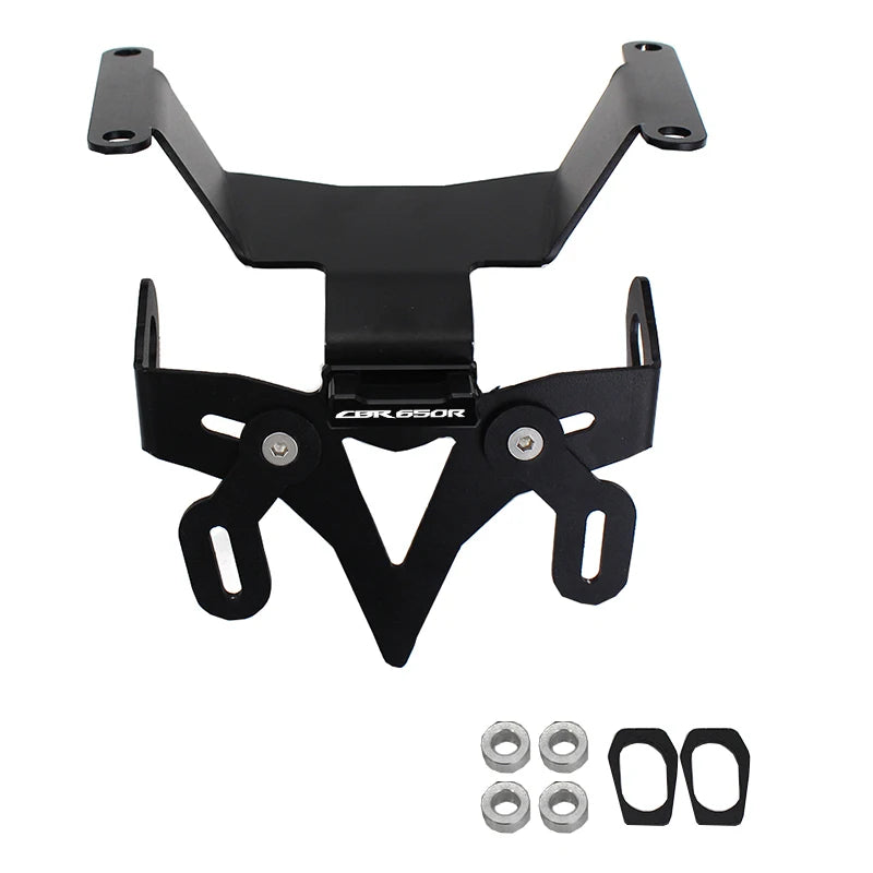 Black metal motorcycle license plate frame with mounting hardware, including four silver nuts and two black rubber gaskets, shown on a plain white background.