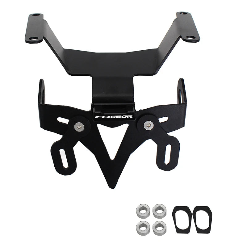 Black metal license plate frame with mounting hardware, including four silver nuts and two black rubber gaskets, shown on a plain white background.