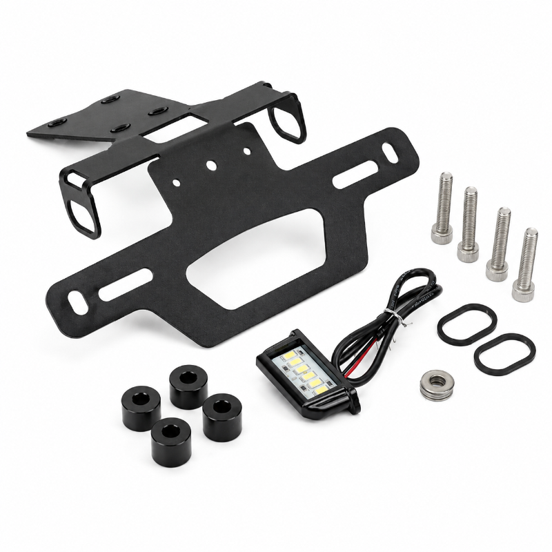 Black metal license plate frame kit with mounting hardware, including two black license plate frames, four black rubber bushings, four silver mounting bolts, two black washers, and a small rectangular LED light module with wiring, shown on a white background.