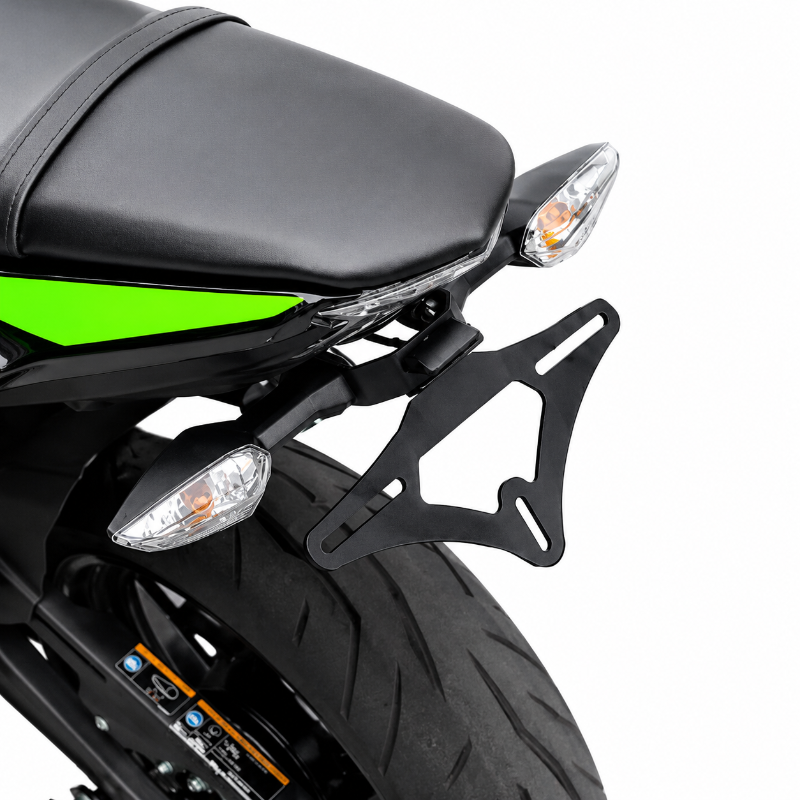 A black metal motorcycle rear rack mounted behind the seat and below the tail light, shown on a white background.