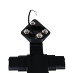 A black metal electrical terminal block with four silver screw terminals and a short black wire lead, shown on a plain white background.