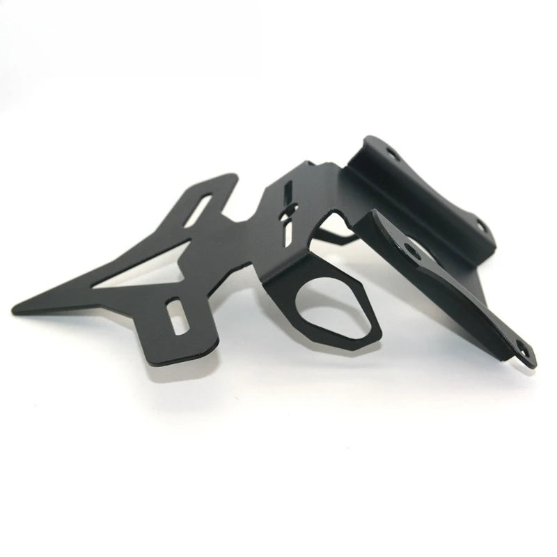 A black metal bracket or mount with cutouts and angled arms, photographed on a clean white background.