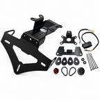 Black metal motorcycle license plate frame kit with mounting brackets, wire harness, zip ties, washers, and a small red button, arranged on a white background.