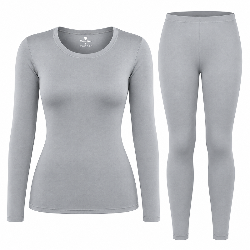 A light gray women's two-piece athletic set featuring a long-sleeve scoop-neck top and matching full-length leggings, displayed on invisible mannequins against a plain white background.