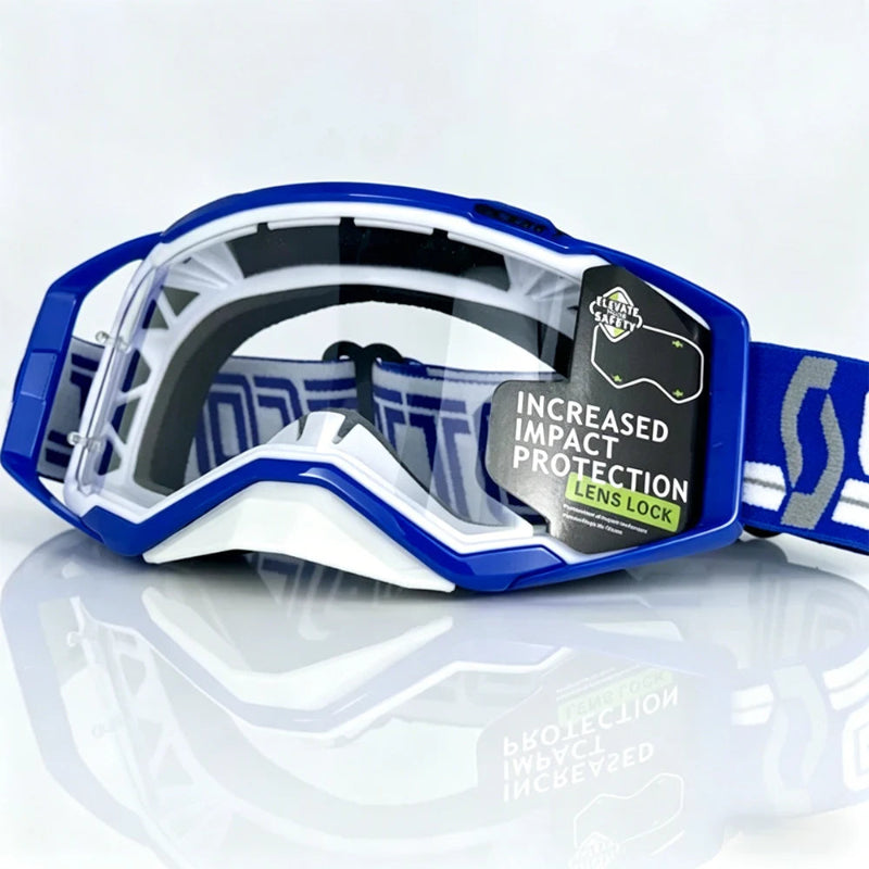 Blue and white motocross goggles with a clear lens, featuring a black and green 'Lens Lock' impact protection sticker, on a reflective white surface.