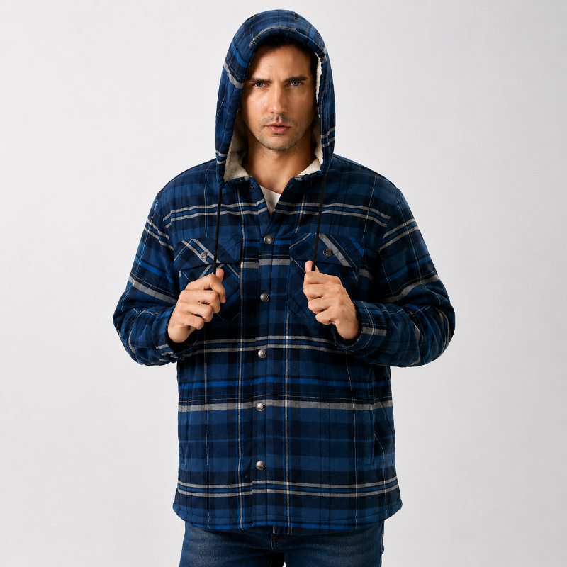 A man wearing a blue hooded button-up flannel shirt jacket with a plaid pattern, posed against a light gray studio background.