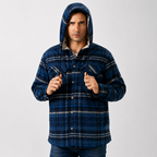 A man wearing a blue hooded button-up flannel shirt jacket with a plaid pattern, posed against a light gray studio background.