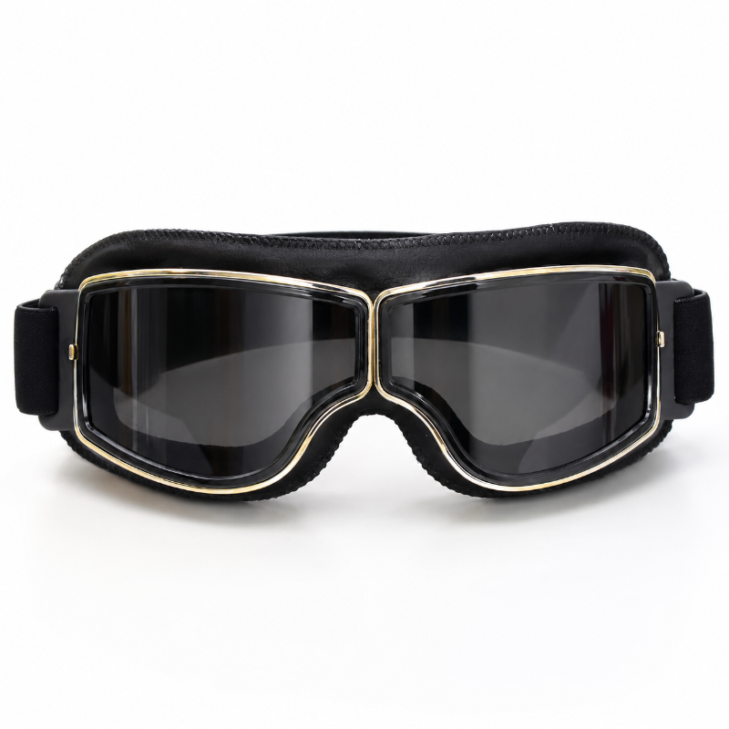 Black ski goggles with a thick padded headband, dark lenses, and gold trim around the frame, shown against a plain white background.