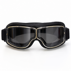 Black ski goggles with a thick padded headband, dark lenses, and gold trim around the frame, shown against a plain white background.