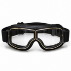 Black aviator-style goggles with a wide adjustable strap and gold trim around the clear lenses, shown on a plain white background.