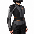 A person wearing a black and gray K-Swiss motorcycle jacket with integrated armor panels, a black riding pants, and a black helmet, shown from the side against a white background.