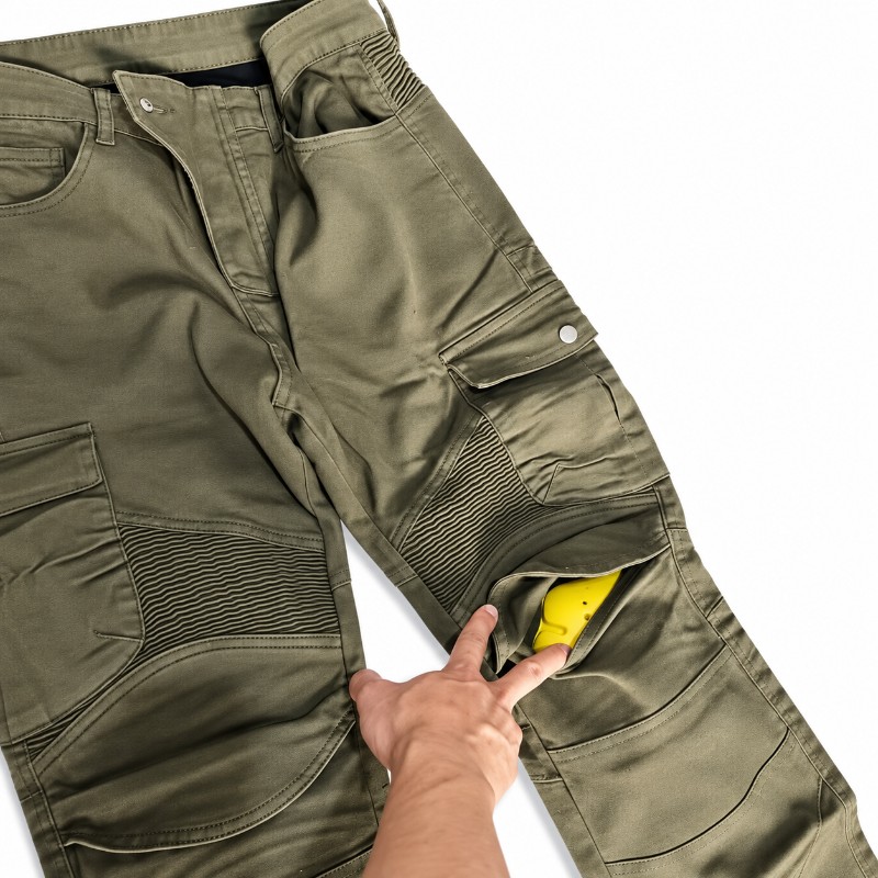 Olive green cargo pants with a hand pulling open a side pocket to reveal a bright yellow interior lining, set against a plain white background.