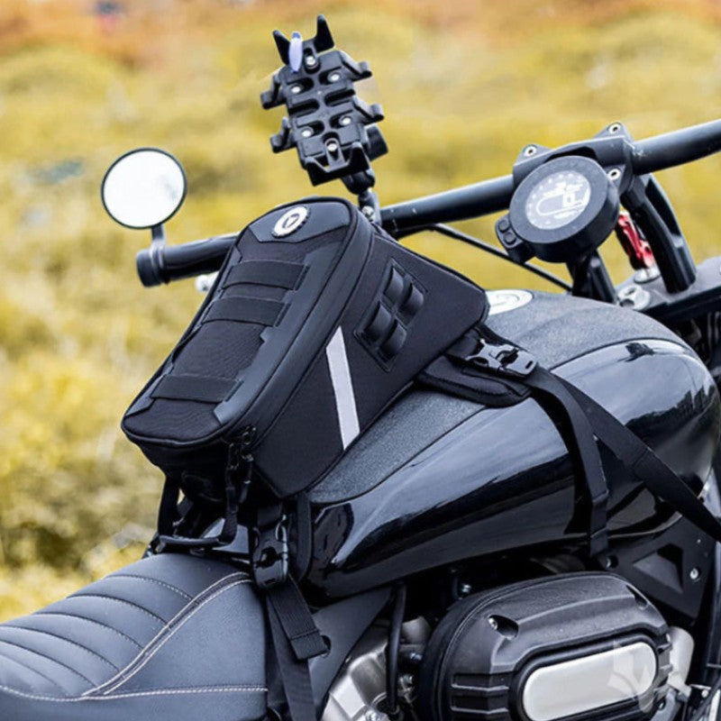 Motorcycle with a black saddlebag and handlebar camera attachment against a blurred natural background